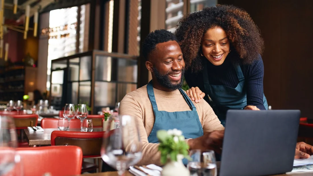 Small business owners reviewing their Google Business Profile results